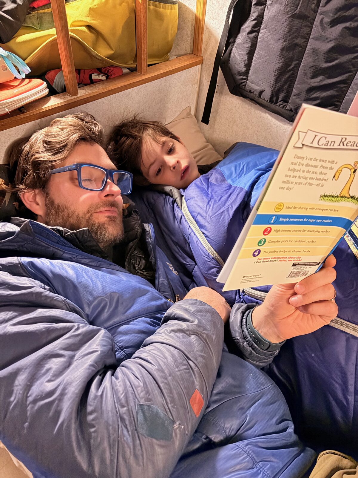 Pat and Ellend snuggled up reading a book together.